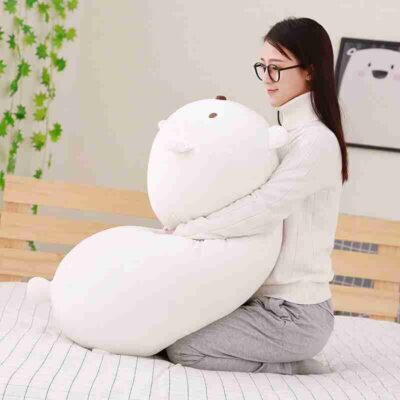 a girl hugs white soothing plush pillow