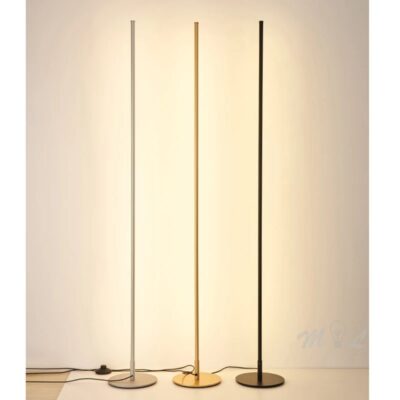 Nordic minimalist LED floor lamp in black, gold and silver, lit with warm light